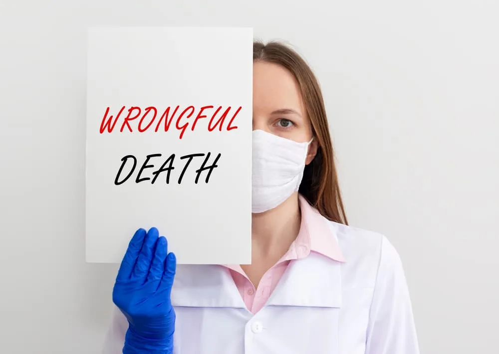 Doctor's handwritten note with medical workspace in the background, emphasizing Wrongful Death concept